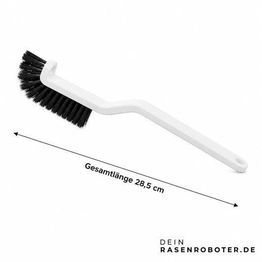 Abgewinkelte Reinigungsbürste zum Entfernen von Grasschnitt am Mähroboter Unterdeck